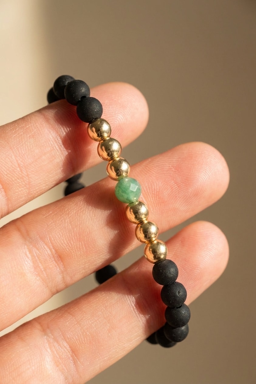 Pulsera Balín Grande 6mm detalle macro sostenida entre dedos en oro laminado 18k NJL Jewelry